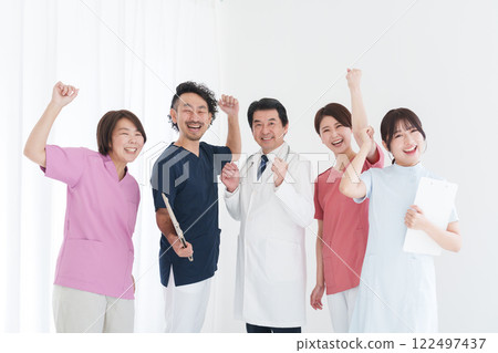 A medical team pumping their fists (multiple people, large group, large number of people, group) A medical team pumping their fists (multiple people, large group, large number of people, group) 122497437