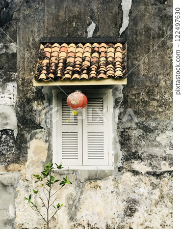 Beautiful rustic Sino-Portuguese architecture background at shophouse building with vintage window and red lantern 122497630