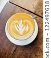 Top view of Hot latte coffee with latte art in a ceramic white cup on wood table 122497638