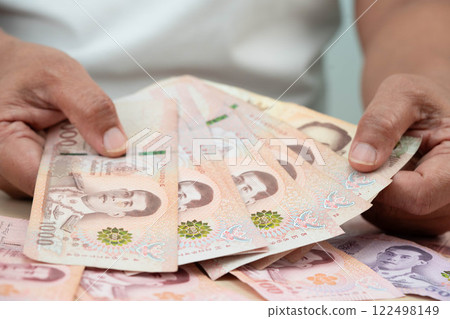 Asian woman counting Thai baht banknote money, investment economy, accounting business and banking. Asian woman counting Thai baht banknote money, investment economy, accounting business and banking. 122498149
