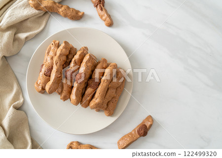 chocolate meringue stick on plate 122499320