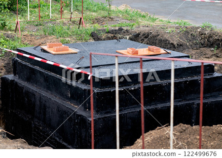 Construction Site Showing Foundation Blocks and Bricks Prepared for Building in a Rural Area During Daytime 122499676