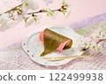Kanto style Sakura mochi with cherry blossom branch and washi paper background 122499938