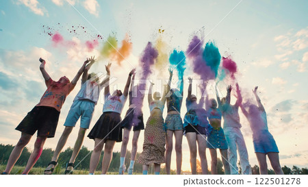 School friends celebrate the end of the year by joyfully throwing colorful powder in the air while jumping School friends celebrate the end of the year by joyfully throwing colorful powder in the air while jumping 122501278