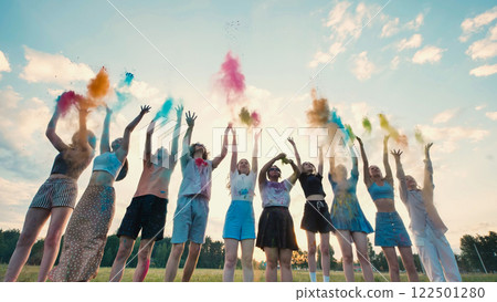 Group of young students throwing colorful holi powder in the air, celebrating the end of school year Group of young students throwing colorful holi powder in the air, celebrating the end of school year 122501280