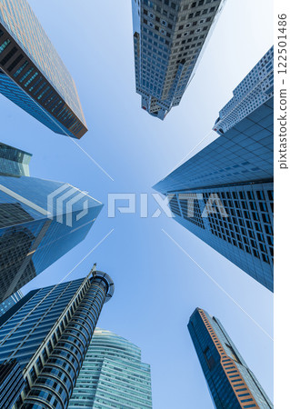 Low-angle building view of the modern office skyscrapers in the financial district of Raffles Place, Singapore. Low-angle building view of the modern office skyscrapers in the financial district of Raffles Place, Singapore. 122501486