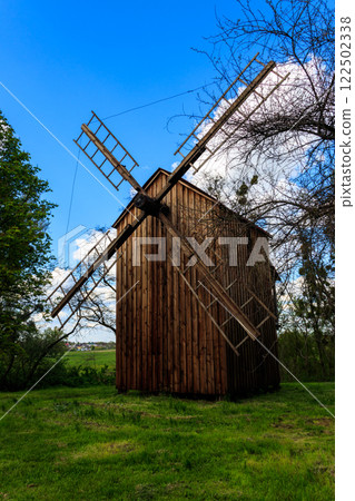 Old wooden windmill in Open-air Museum of Folk Architecture and Folkways of Middle Naddnipryanschina in Pereyaslav, Ukraine Old wooden windmill in Open-air Museum of Folk Architecture and Folkways of Middle Naddnipryanschina in Pereyaslav, Ukraine 122502338