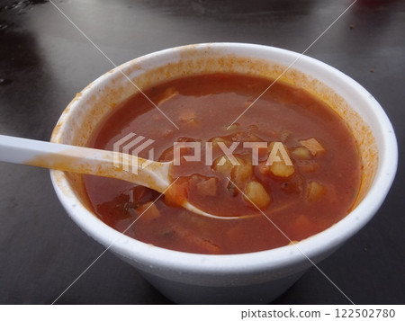 [Latvia] Minestrone soup with lots of ingredients served in a white cup (Riga) 122502780
