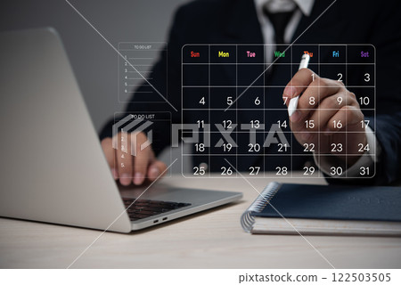 Businessman holding pen marks on virtual screen calendar, business marketing Planning Calendar Agenda work schedule, time management Workflow to do list 122503505
