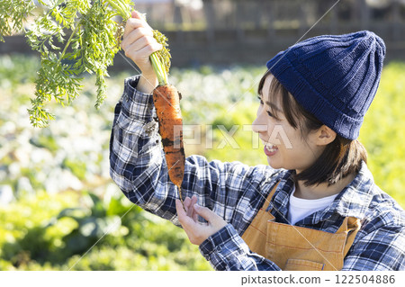 Image of a female farmer working in the fields Image of a female farmer working in the fields 122504886