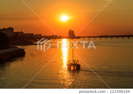 Modern yacht sailing on the Dnieper river at sunset in Dnipro, Ukraine 122506284