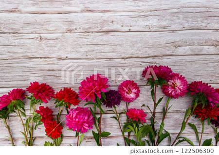 Aster flowers on wooden background. Top view, copy space Aster flowers on wooden background. Top view, copy space 122506300