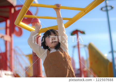 Girls playing in the clouds in the park Girls playing in the clouds in the park 122507688