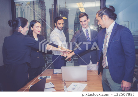Group business team collaboration and unity while hand stacking with success together in office. Group business team collaboration and unity while hand stacking with success together in office. 122507985