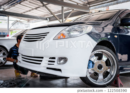 Checking car body work fiber bumper at car garage 122508390