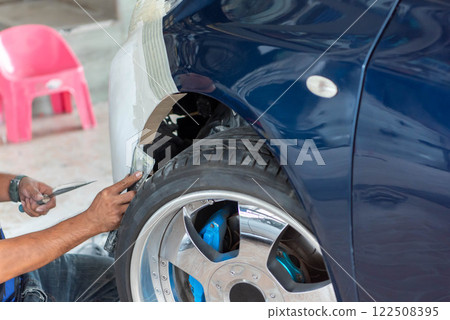 Checking car body work fiber bumper at car garage Checking car body work fiber bumper at car garage 122508395