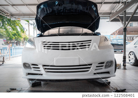 Checking car body work fiber bumper at car garage Checking car body work fiber bumper at car garage 122508401