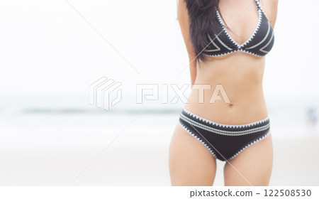 Beautiful young asian woman standing with happiness for relax on beach in tropical. 122508530