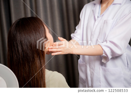 Young asian patient woman consulting with doctor in coat about wrinkle and skin for rejuvenate. Young asian patient woman consulting with doctor in coat about wrinkle and skin for rejuvenate. 122508533