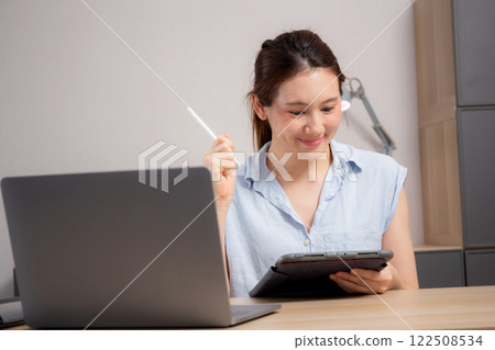Young caucasian business woman using digital tablet for success in modern home office. Young caucasian business woman using digital tablet for success in modern home office. 122508534