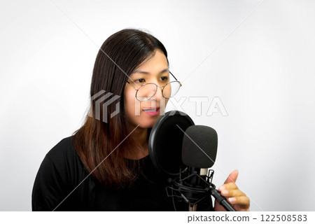 Woman (LGBTQ) singer sing a song with microphone 122508583