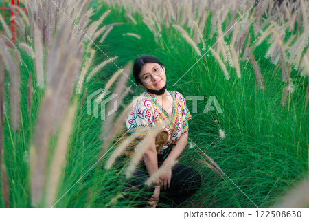 Woman (LGBTQ) posing at flower park garden field 122508630