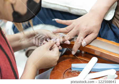 Woman (LGBTQ) do a manicure or pedicure at nails Woman (LGBTQ) do a manicure or pedicure at nails 122508641