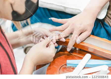 Woman (LGBTQ) do a manicure or pedicure at nails Woman (LGBTQ) do a manicure or pedicure at nails 122508643