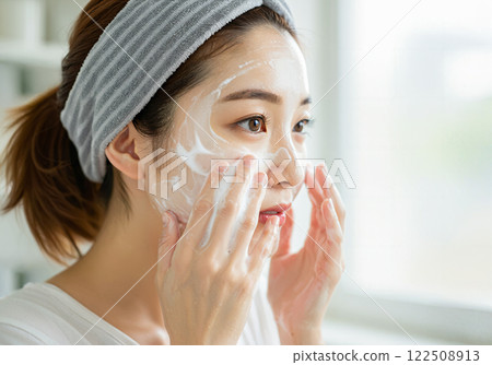 Young woman doing facial massage 122508913