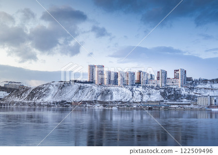 Beautiful view of a residential neighborhood of apartment buildings on a winter evening on the banks of the Yenisei River in Krasnoyarsk, Russia. A Beautiful SnowCovered Urban Landscape Featuring Beautiful view of a residential neighborhood of apartment buildings on a winter evening on the banks of the Yenisei River in Krasnoyarsk, Russia. A Beautiful SnowCovered Urban Landscape Featuring 122509496