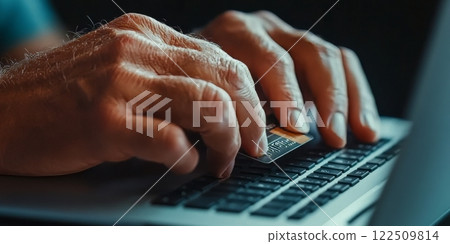 Senior man using credit card while shopping online on laptop 122509814