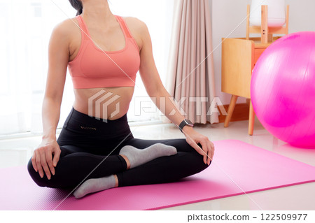 Young asian woman meditation sitting on mat in serene and tranquility with yoga posture lotus. Young asian woman meditation sitting on mat in serene and tranquility with yoga posture lotus. 122509977