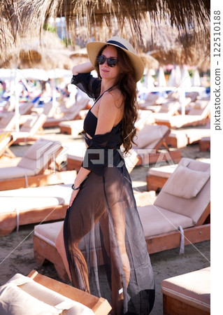 Stylish woman enjoying beachside resort ambiance  122510188