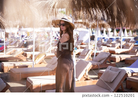 Stylish woman in black beach outfit at resort  122510201