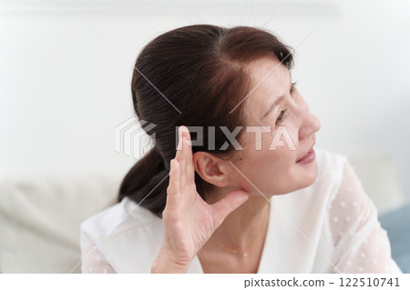 Senior woman listening to rumors Senior woman listening to rumors 122510741