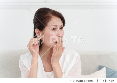 Senior woman with earlobe problems Senior woman with earlobe problems 122510746