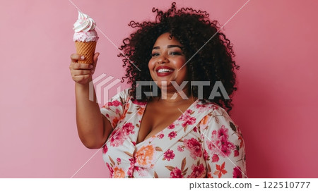 A woman holding an ice cream cone in her hand 122510777