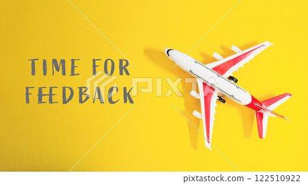 Small airplane is on a yellow background with the words Time for feedback 122510922
