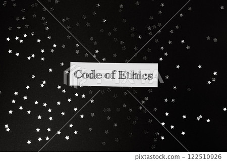 Code of ethics is written on a black background with a star pattern 122510926