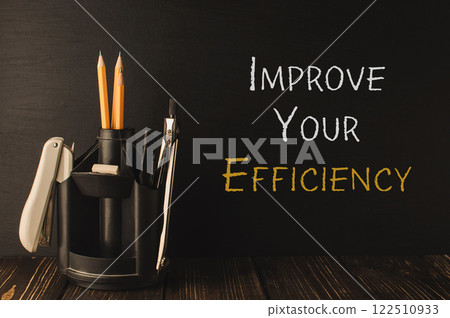 Pencil holder with a pair of pencils and a pen sits on a wooden table Pencil holder with a pair of pencils and a pen sits on a wooden table 122510933