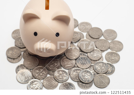 Pig money box and lots of 100 yen coins Pig money box and lots of 100 yen coins 122511435