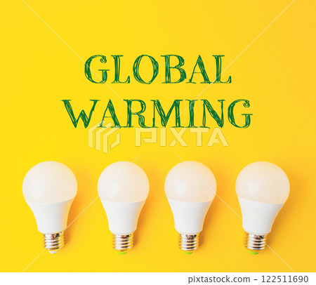 A group of four light bulbs on a yellow background with the words Global Warming A group of four light bulbs on a yellow background with the words Global Warming 122511690