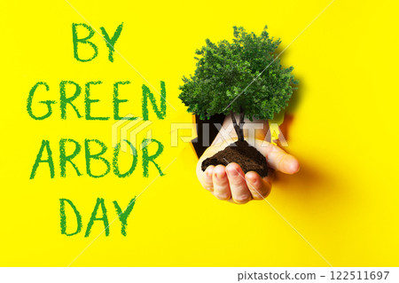 a yellow background with the words By Green Arbor Day 122511697