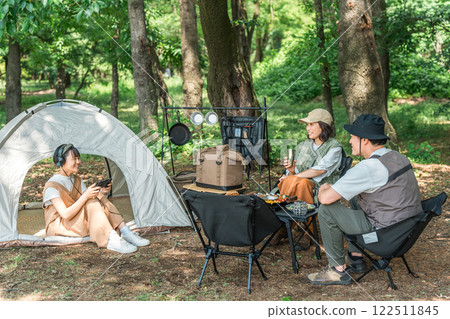 Couple and children playing games at family camp (Family/Travel) Couple and children playing games at family camp (Family/Travel) 122511845