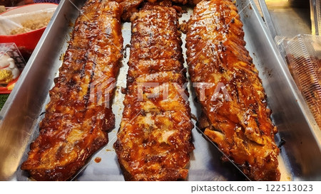 Grilled Barbecue Ribs With Rich Glaze on Metal Tray in Restaurant Grilled Barbecue Ribs With Rich Glaze on Metal Tray in Restaurant 122513023