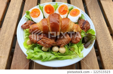 Delicious Croissant with Egg and Meat on Fresh Green Salad Plate Delicious Croissant with Egg and Meat on Fresh Green Salad Plate 122513323