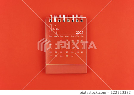 July 2025 red color desk calendar on red background. July 2025 red color desk calendar on red background. 122513382