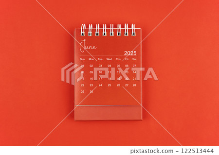 June 2025 red color desk calendar on red  background. 122513444