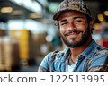 Smiling truck driver and industrial warehouse setting on background. 122513995