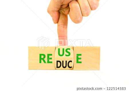Reuse or reduce symbol. Concept words Reuse Reduce on wooden block. Beautiful white table white background. Businessman hand. Business reuse or reduce concept. Copy space. Reuse or reduce symbol. Concept words Reuse Reduce on wooden block. Beautiful white table white background. Businessman hand. Business reuse or reduce concept. Copy space. 122514383